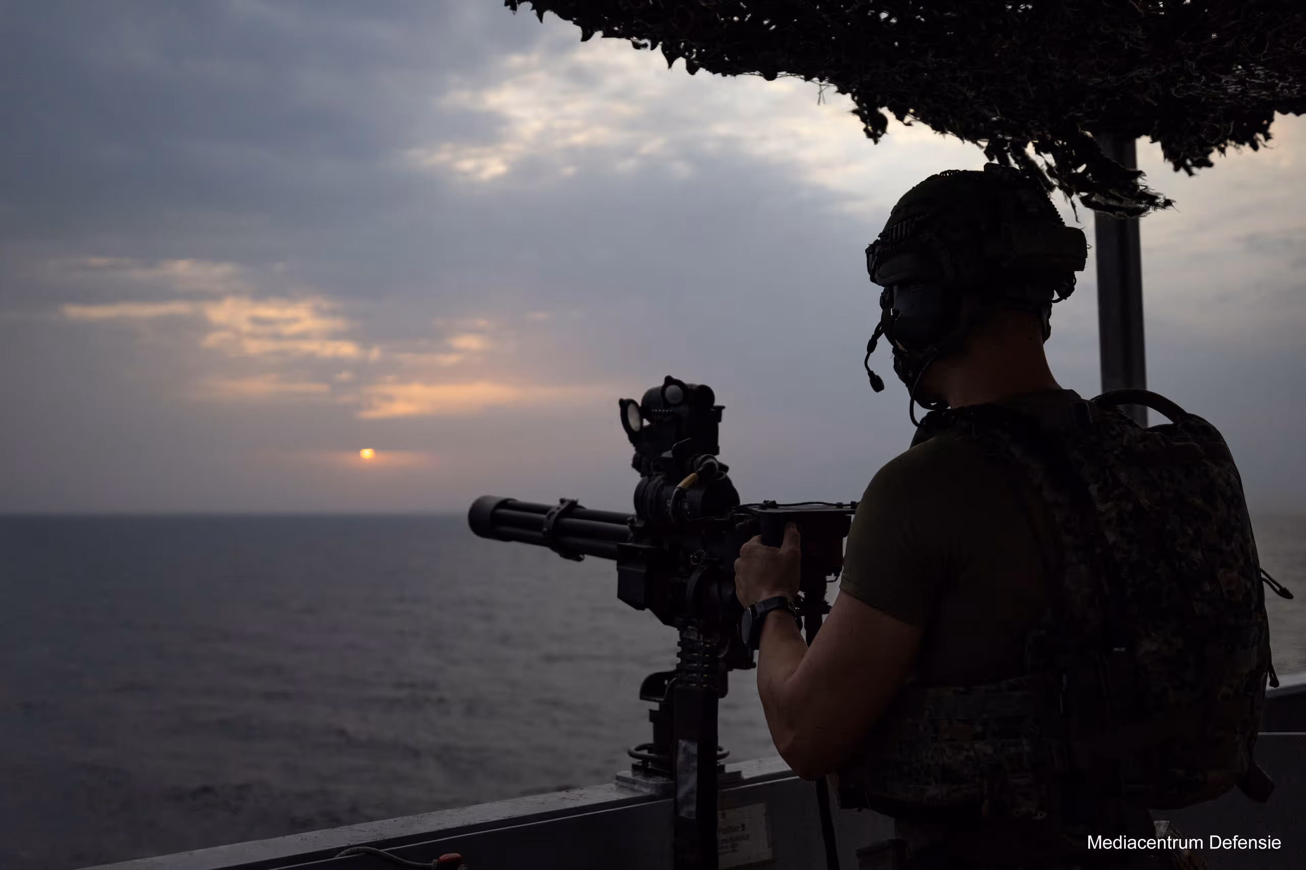 Photo of a soldier behind a rifle looking out over the Red Sea.